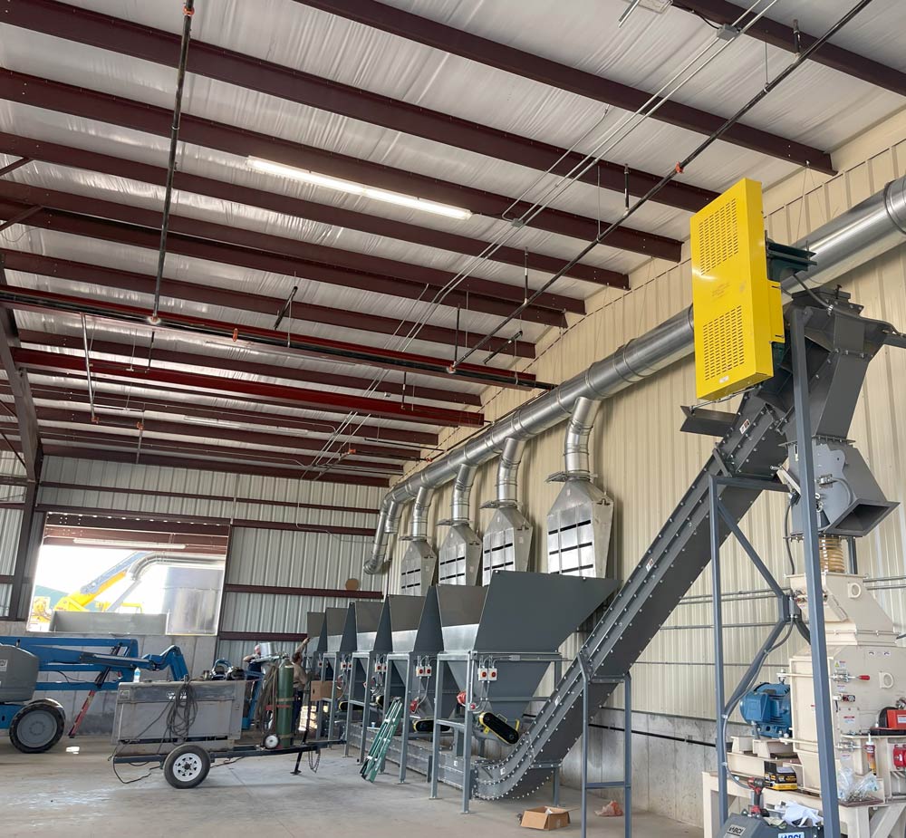 industrial ductwork system connected to dust collection equipment in manufacturing facility