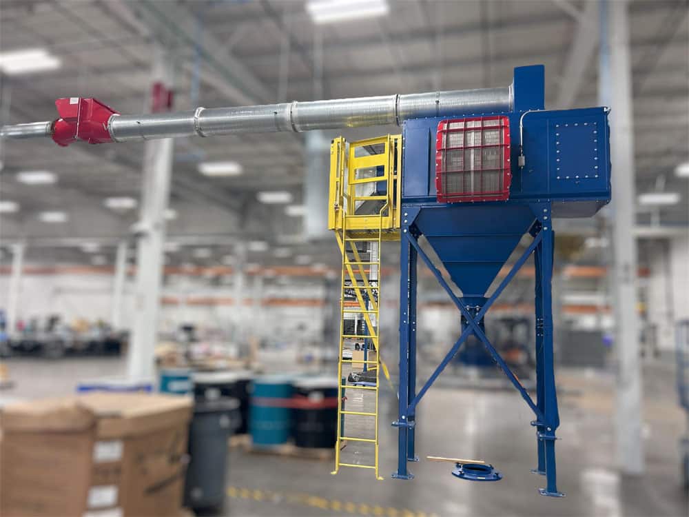 Baghouse dust collector with deflagration vent panel and access ladder in an industrial warehouse