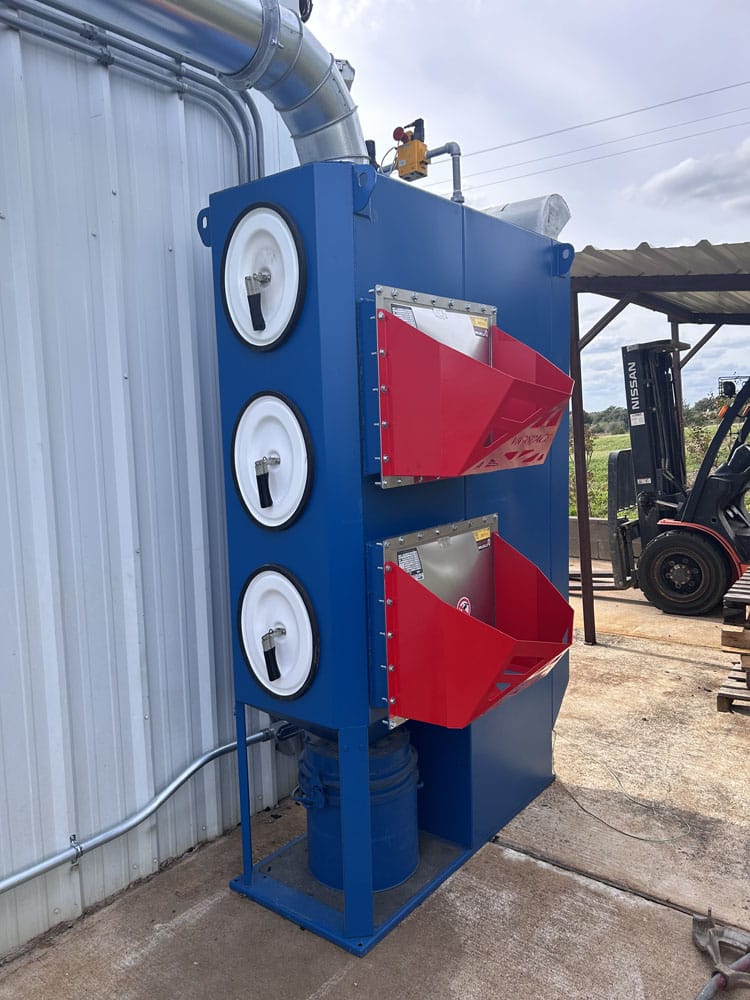 NFPA-compliant cartridge dust collector with deflagration vent panels at an industrial facility