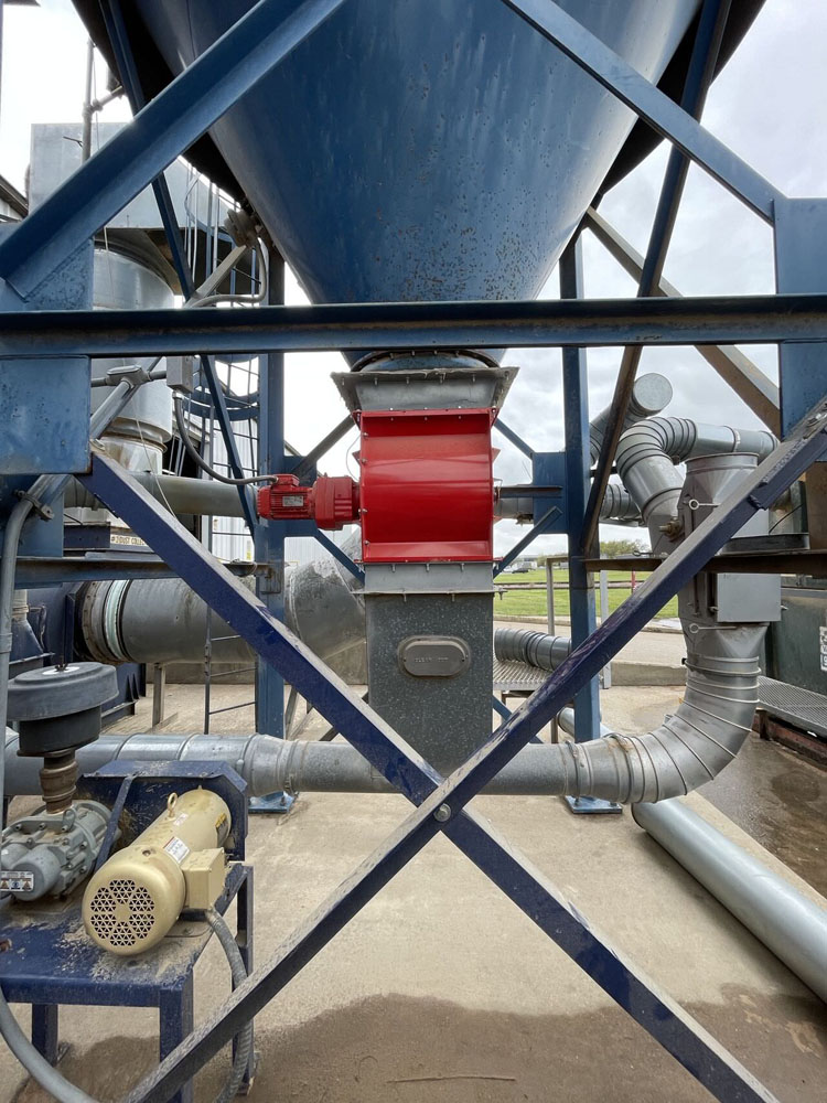 Rotary airlock valve beneath a bulk powder hopper in a combustible dust control system