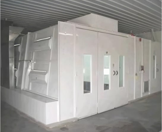 Custom industrial spray booth with integrated air handling unit installed in manufacturing facility