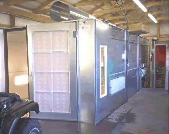 Custom industrial paint booth with exhaust ducting installed in industrial shop