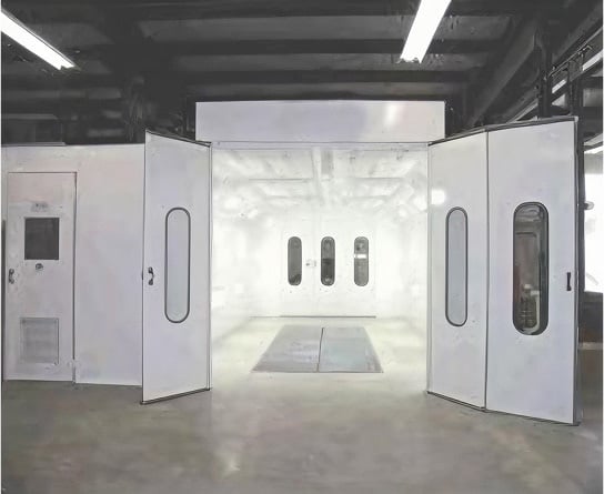 Industrial downdraft paint booth with double doors and floor grate system installed in manufacturing facility